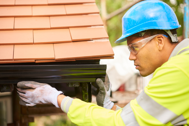 Beaverton Worker Installing gutters