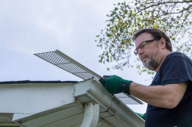 Beaverton Gutter Contractor Examining Plastic Leaf Guard